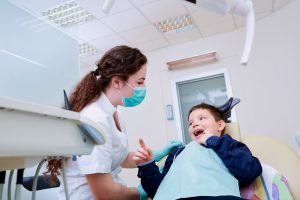 child with dentist in dental chair